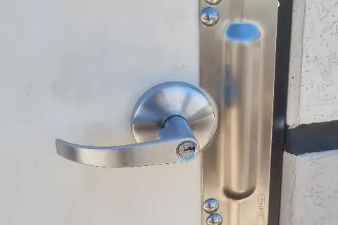 Commercial lever lock with stainless anti-jemmy blocker plate fitted to an external door in Perth