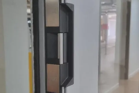 Electric strike fitted to an aluminium glass partition door during a Perth office fit-out