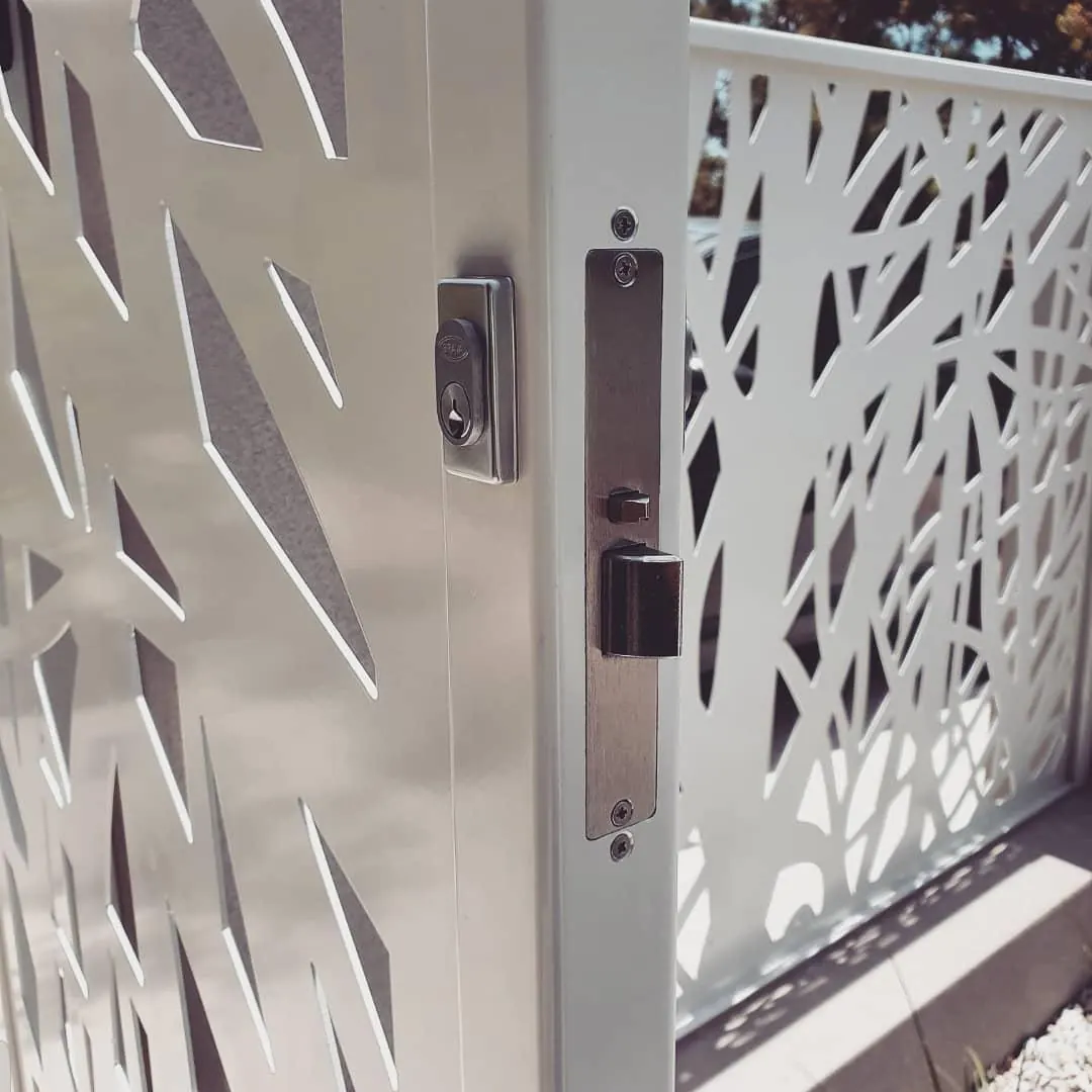 Keyed gate lock installed on a white laser-cut decorative aluminium gate in Perth