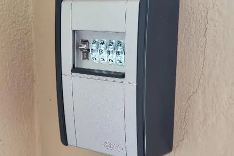 ABUS combination key safe lock box mounted on an exterior wall in Perth
