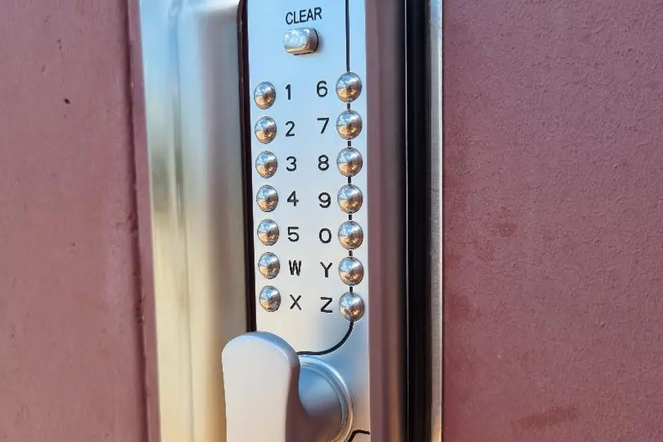 Stainless push-button digital code lock and anti-jemmy blocker plate fitted to a commercial door in Perth