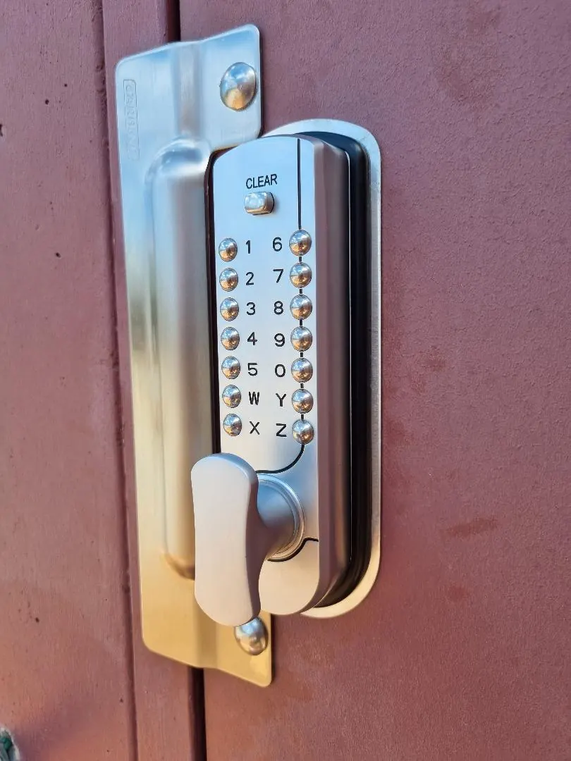 Stainless push-button digital code lock and anti-jemmy blocker plate fitted to a commercial door in Perth