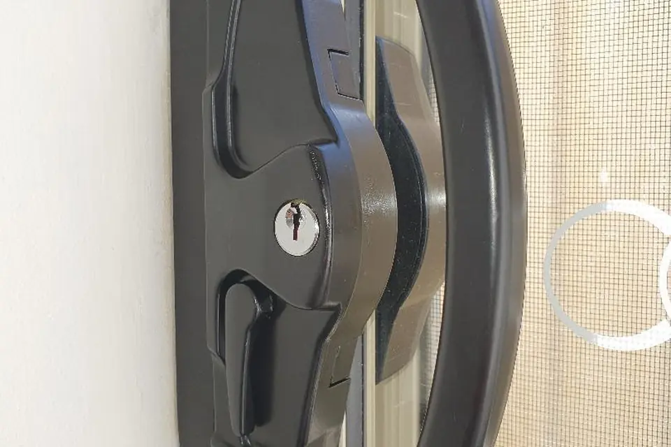 Black keyed sliding security screen door lock fitted on a Perth home